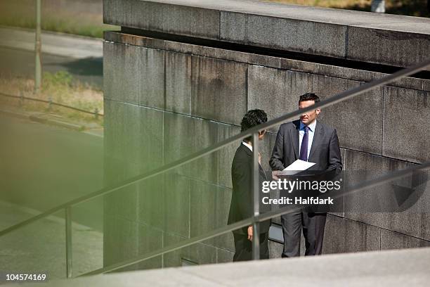 two businessmen conducting suspicious business - 汚職 ストックフォトと画像