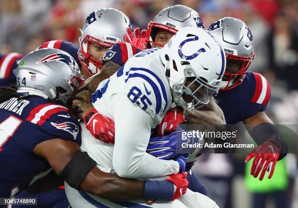 Eric Ebron of the Indianapolis Colts is tackled by Patrick Chung and Dont'a Hightower of the New England Patriots during the first half at Gillette...