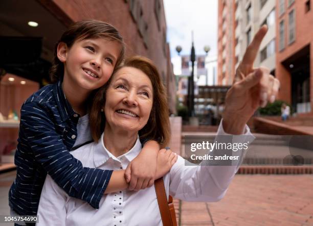 loving grandmother and grandson pointing away - basslet stock pictures, royalty-free photos & images