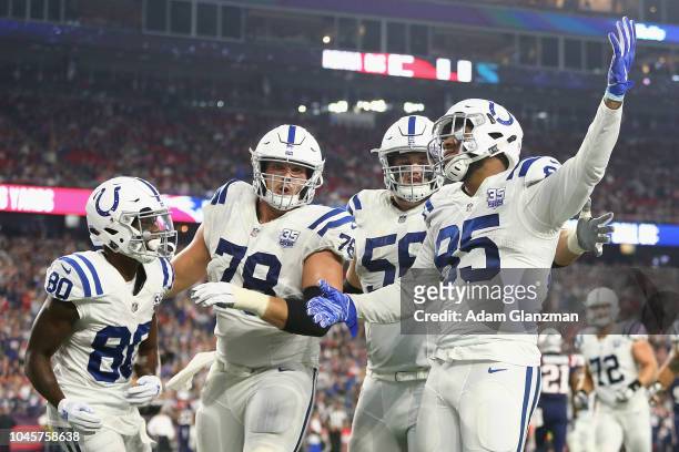 Eric Ebron of the Indianapolis Colts celebrates scoring a touchdown during the third quarter against the New England Patriots at Gillette Stadium on...