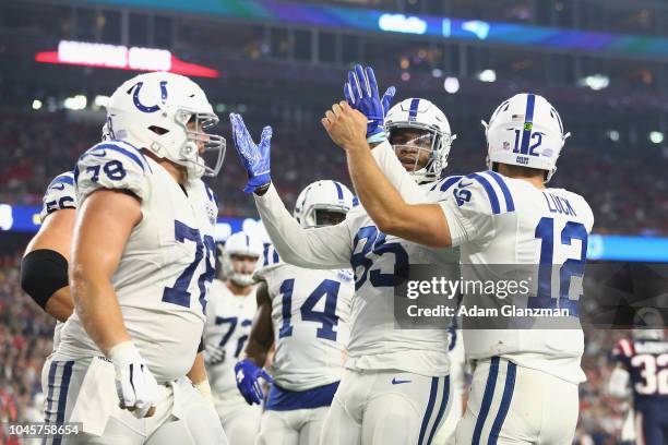 Eric Ebron and Andrew Luck of the Indianapolis Colts celebrate with teammates after scoring a touchdown during the third quarter against the New...