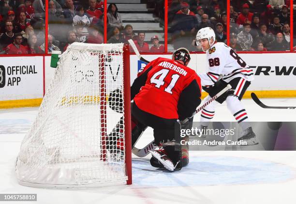 Patrick Kane of the Chicago Blackhawks gets the puck past Craig Anderson of the Ottawa Senators to score an overtime goal at Canadian Tire Centre on...