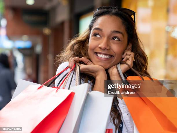 excited shopping woman looking very happy holding bags - shopping excitement stock pictures, royalty-free photos & images