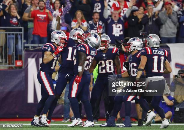 Josh Gordon of the New England Patriots celebrates with teammates after catching a touchdown pass from Tom Brady during the fourth quarter against...