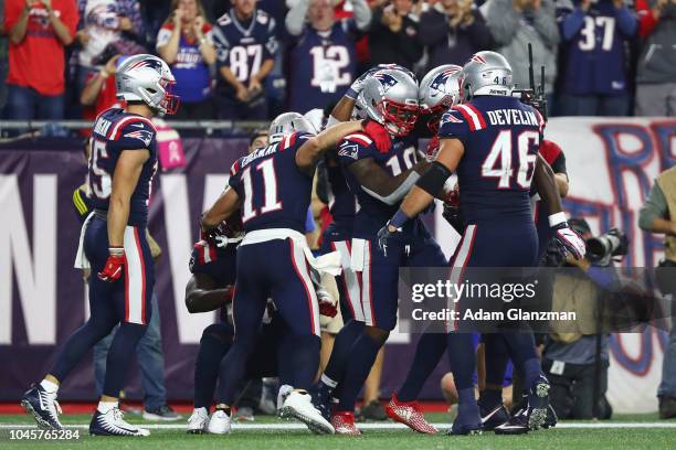 Josh Gordon of the New England Patriots celebrates with teammates after catching a touchdown pass from Tom Brady during the fourth quarter against...