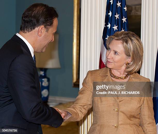 Secretary of State Hillary Clinton shakes hands with Panamanian Vice President and Foreign Minister Juan Carlos Varela speak during a press...