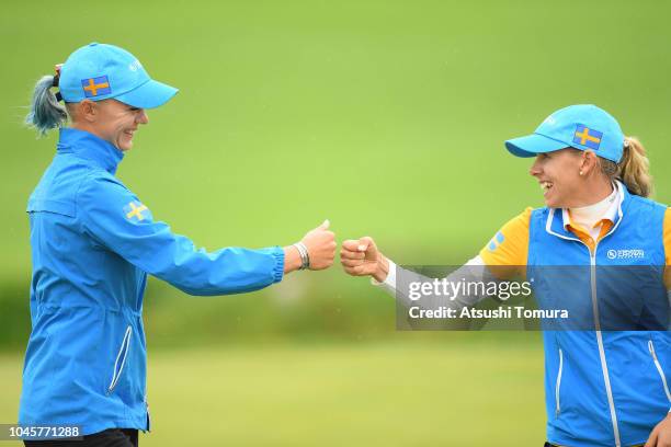 Pernilla Lindberg and Madelene Sagstrom of Sweden celeberate on the 15th hole in the Pool B match between Japan and Sweden on day two of the UL...