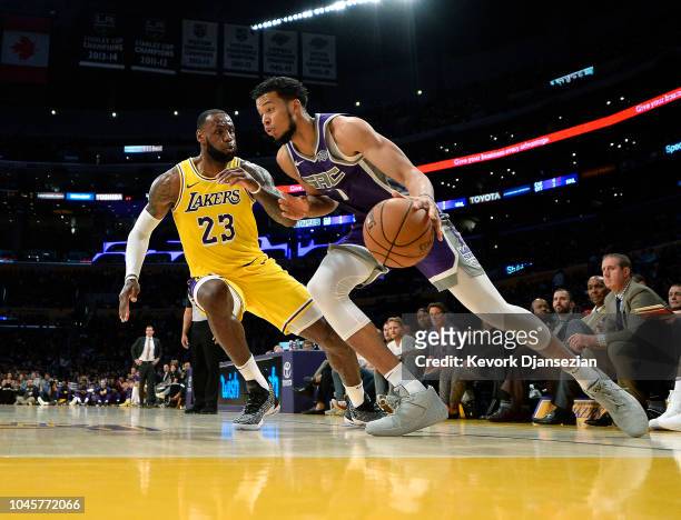 LeBron James of the Los Angeles Lakers defends against Skal Labissiere of the Sacramento Kings during the first half at Staples Center on October 4,...