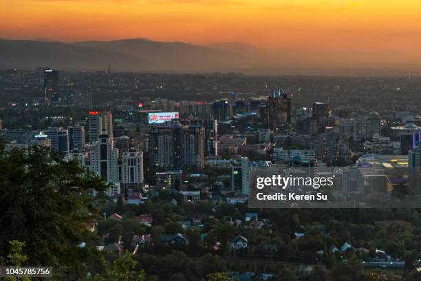 sunset view of almaty cityscape from kok-tobe hill, almaty, kazakhstan - kazakhstan skyline stock pictures, royalty-free photos & images