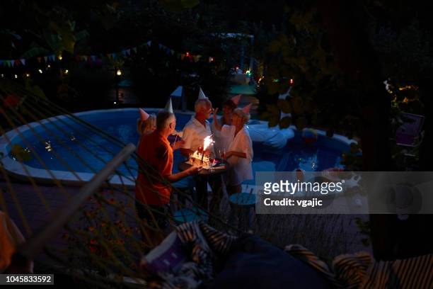 seniors birthday party by the pool - pool party night stock pictures, royalty-free photos & images