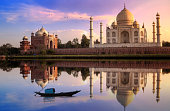Taj Mahal Agra India at sunset with mirror reflection and vibrant sky. Taj Mahal is located at the banks of river Yamuna.