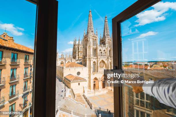 personal perspective of a man opening window and looking at burgos cathedral, spain - open city bildbanksfoton och bilder