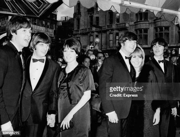 The Beatles, left to right, Paul McCartney, Ringo Starr with his wife Maureen, John Lennon with wife Cynthia and George Harrison, pose for...