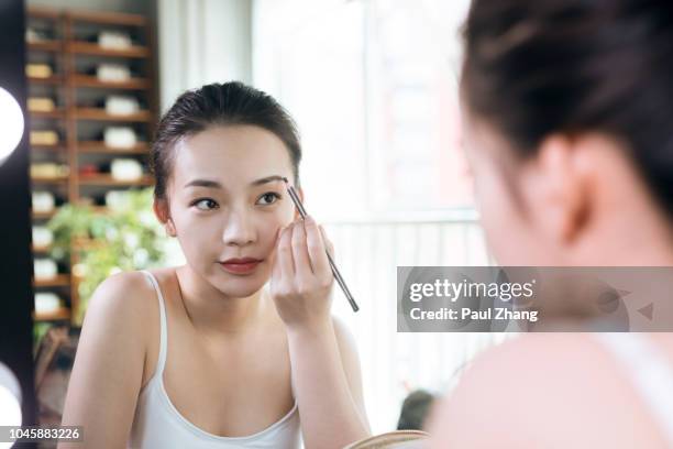 young woman doing makeup. - eyebrow pencil fotografías e imágenes de stock