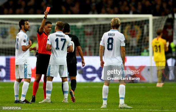 Referee Serdar Gozubuyuk shows Dusan Basta the red card during the UEFA Europa League Group H match between Eintracht Frankfurt and SS Lazio at...