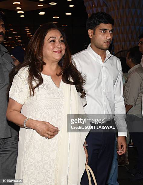 Indian Bollywood actress Tina Ambani with her son attends a prayer meet for the late Krishna Raj Kapoor, wife of late actor Raj Kapoor in Mumbai on...