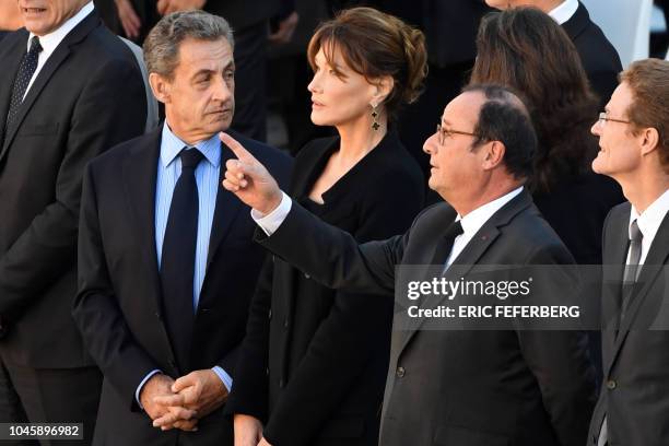 Former French President Nicolas Sarkozy and his wife singer Carla Bruni and former French President Francois Hollande attend the national homage to...