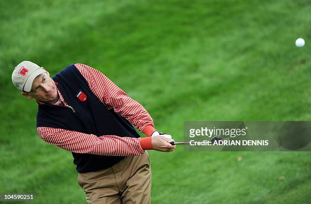 Ryder Cup player Jim Furyk chips out of the rough during a practice session at Celtic Manor golf course in Newport, Wales on September 30, 2010. The...
