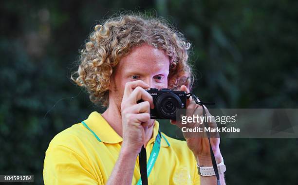 Steve Hooker takes pictures of the media as he arrives at the Australian Team Reception and announcement of the opening ceremony flag bearer for the...