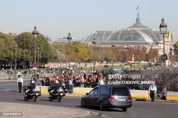 The hearse carrying the coffin of French-Armenian singer-songwriter Charles Aznavour leaves following France's national homage held at the Invalides...