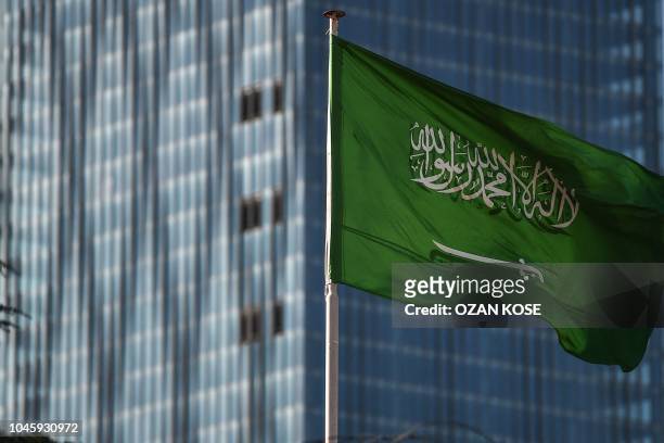 Saudi Arabian flag flies at the Saudi Arabian consulate in Istanbul on October 5 as protestors take part in a demonstration demanding the release of...