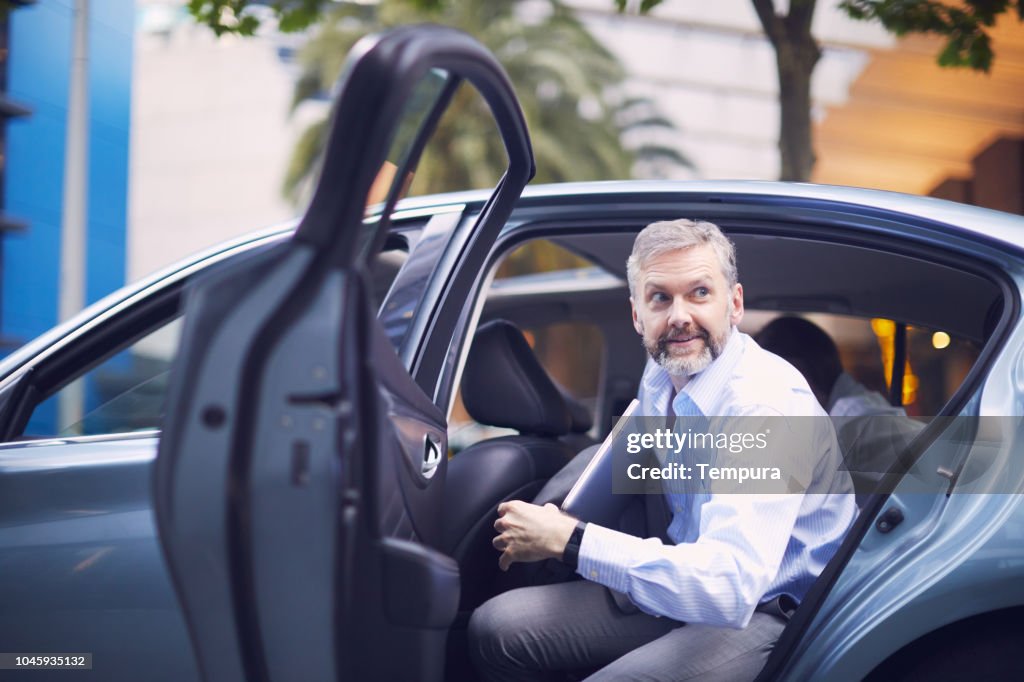 Business on the move, riding a car.