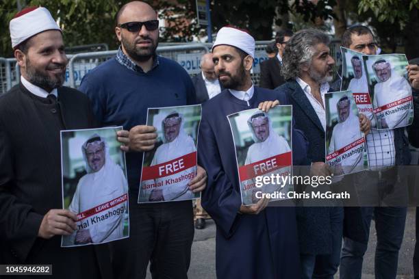 People hold posters of Saudi journalist Jamal Khashoggi during a protest organized by members of the Turkish-Arabic Media Association at the entrance...