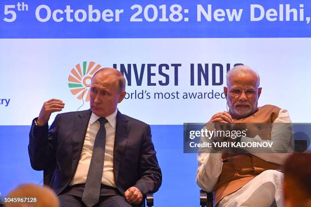 Russian President Vladimir Putin and Indian Prime Minister Narendra Modi attend a Russian-Indian business summit session in New Delhi on October 5,...