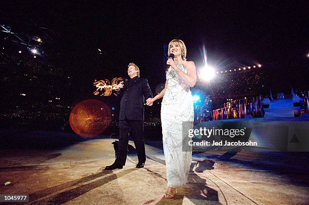 John Farnham and Olivia Newton-John sing during the Opening Ceremony of the Sydney 2000 Olympic Games at the Olympic Stadium in Homebush Bay, Sydney,...