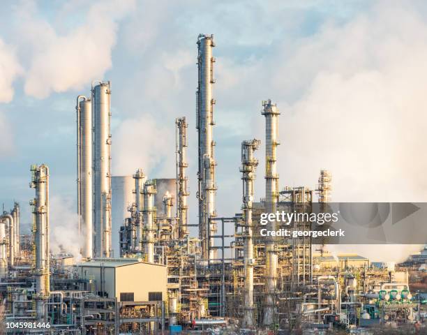 modern oil refinery towers - oil refinery stock pictures, royalty-free photos & images