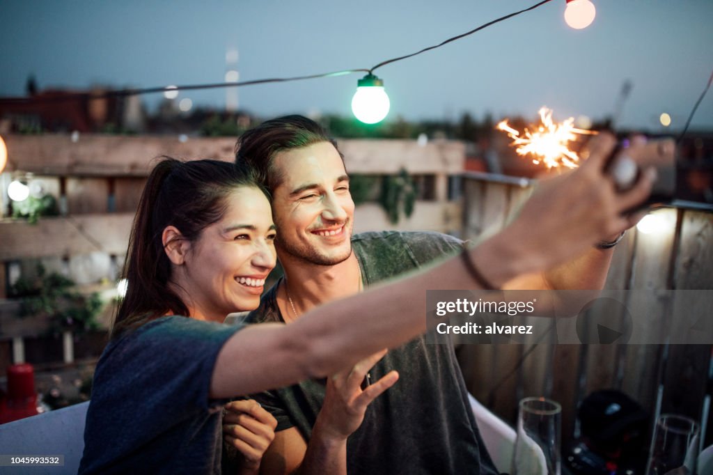 Fun Rooftop Party Couple Capturing Fun Moments At Rooftop Party High-Res Stock Photo ...