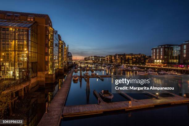 city lights across river nidelva in trondheim - trondheim norway stock pictures, royalty-free photos & images