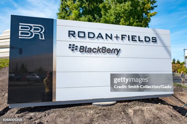 Close-up of sign with logos for Rodan and Fields and Blackberry at the Bishop Ranch office park in San Ramon, California, September 26, 2018.