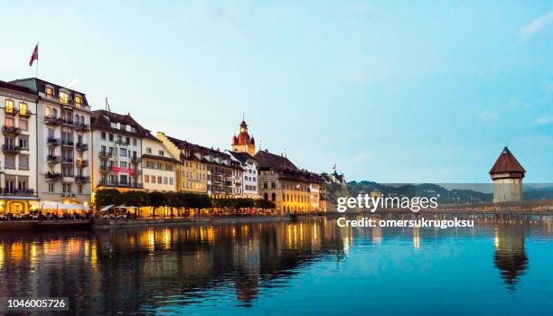 view of chapel bridge on river reuss with lucerne city skyline at sunset in switzerland - skyline luzern stock pictures, royalty-free photos & images