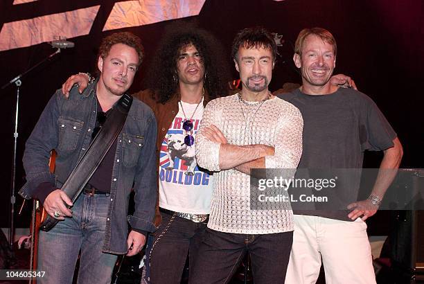 Neal Schon , Slash of Guns N' Roses, Paul Rodgers of Bad Company, and Simon Kirke of Bad Company pose for pictures during a break at the sound check...