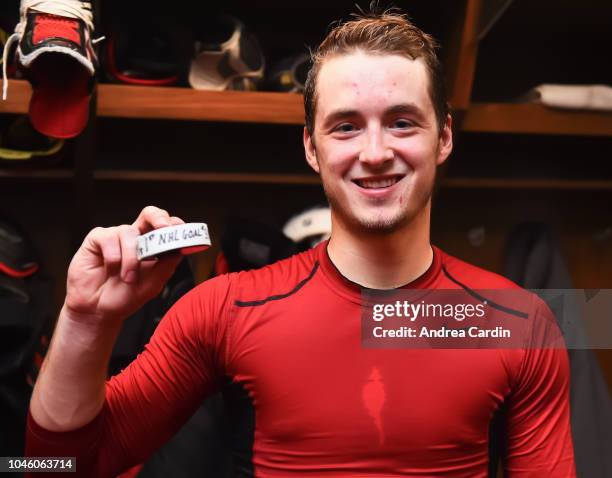 Maxime Lajoie of the Ottawa Senators poses with the puck with which he scored his first career NHL goal, after a game against the the Chicago...