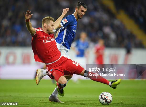 Aaron Hunt of Hamburg is challenged by Serdar Dursun of Darmstadt during the Second Bundesliga match between SV Darmstadt 98 and Hamburger SV at...