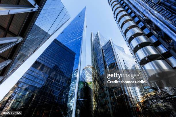 looking up at futuristic london skyscrapers - multiple exposure - lloyds of london imagens e fotografias de stock