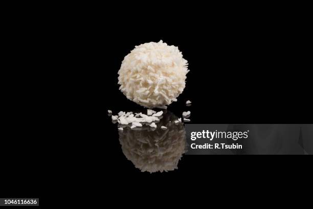 white sweet chocolate, covered the coconut shaving on a dark background - coconut shaving stock pictures, royalty-free photos & images