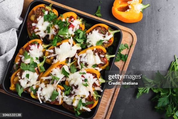 overhead view of stuffed bell peppers - roasted pepper stock-fotos und bilder