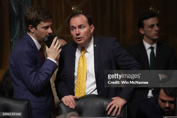 Senate Judiciary Committee member Sen. Mike Lee confers with an aide during a committee meeting while Sen. Jeff Flake was conferring with Democratic...
