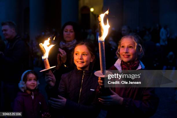 Two girls with torches during the memorial procession for the deceased musician Kim Larsen on October 5, 2018 in Copenhagen, Denmark. Kim Larsen died...