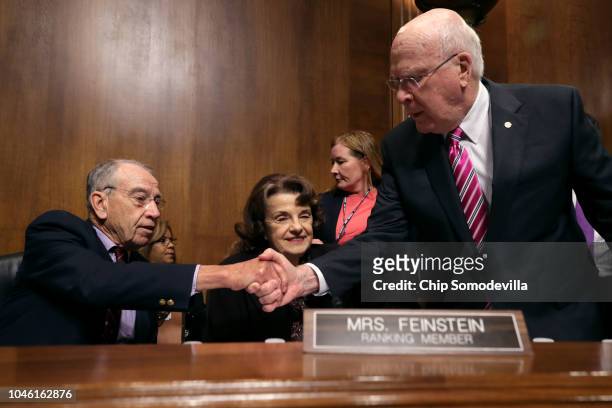 Senate Judiciary Committee Chairman Charles Grassley shakes hands with committee member Sen. Patrick Leahy as they and raking member Sen. Dianne...