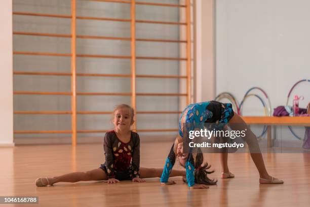 young ballerinas dancers doing practice in ballet studio. - floor gymnastics stock pictures, royalty-free photos & images