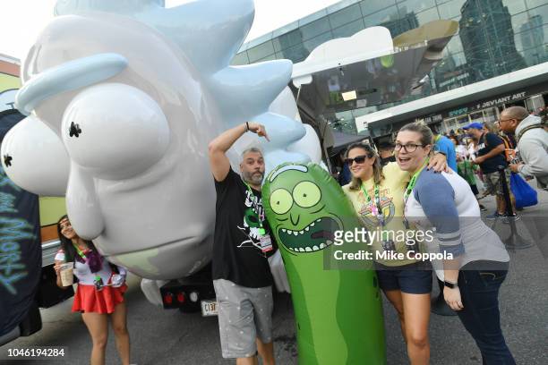 Fans pose next to the Rickmobile during New York Comic Con 2018 at Jacob Javits Center on October 5, 2018 in New York City. 423701