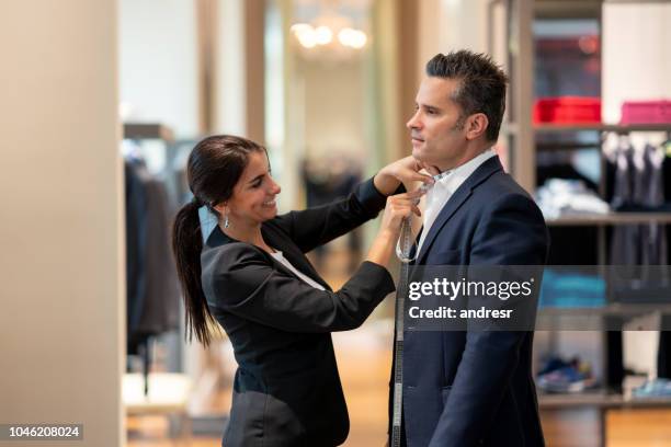 man getting measurements at a clothing store - tailored suit stock pictures, royalty-free photos & images