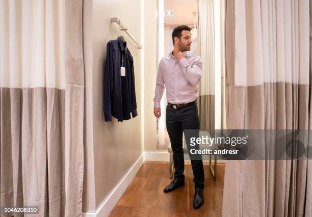 shopping man trying clothes in the fitting room - mens changing room stock pictures, royalty-free photos & images