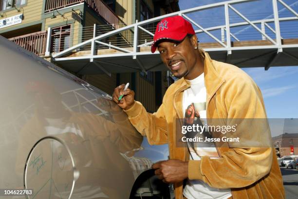 Darrin Dewitt Henson autographs a 2005 Chevrolet Silverado Pickup which General Motors will donate to the National Ability Center, a local charity...