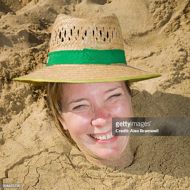 buried in the sand - head in sand stock-fotos und bilder