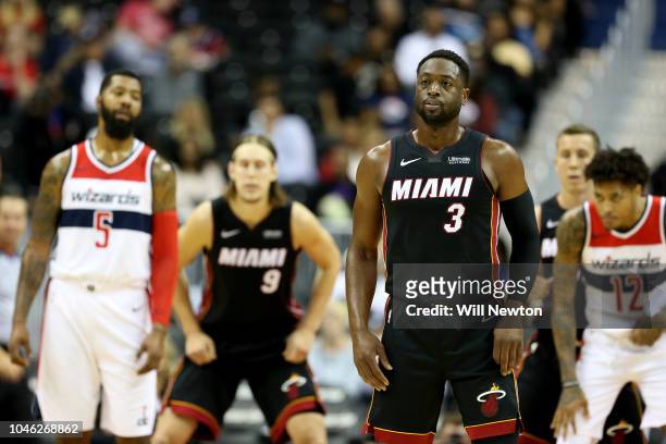 Dwyane Wade of the Miami Heat looks on against the Washington Wizards during the first half of a preseason NBA game at Capital One Arena on October...